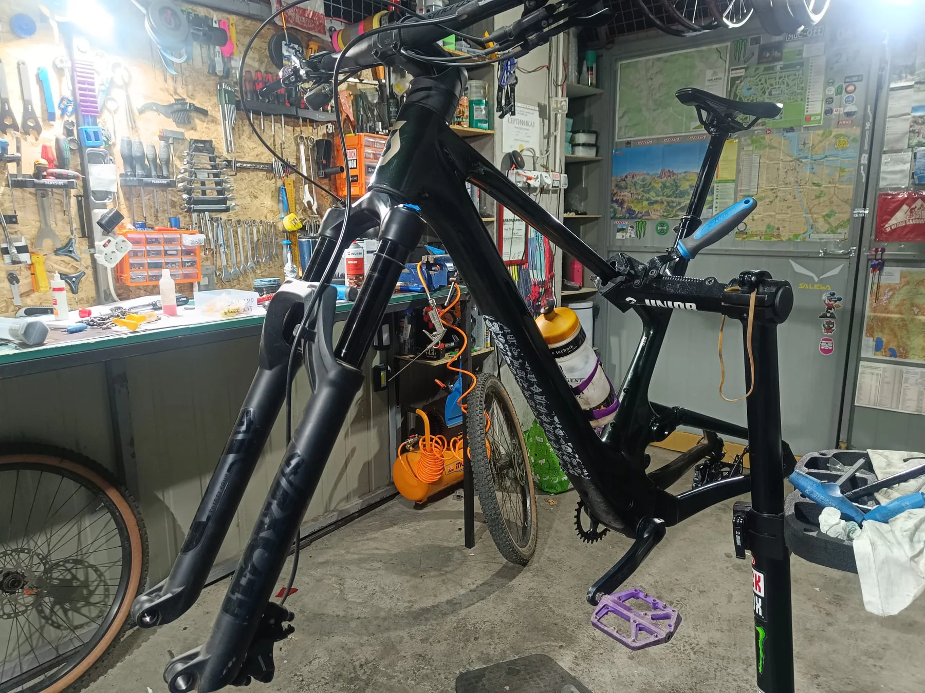 Mountain bike frame on a service stand, with wheels removed