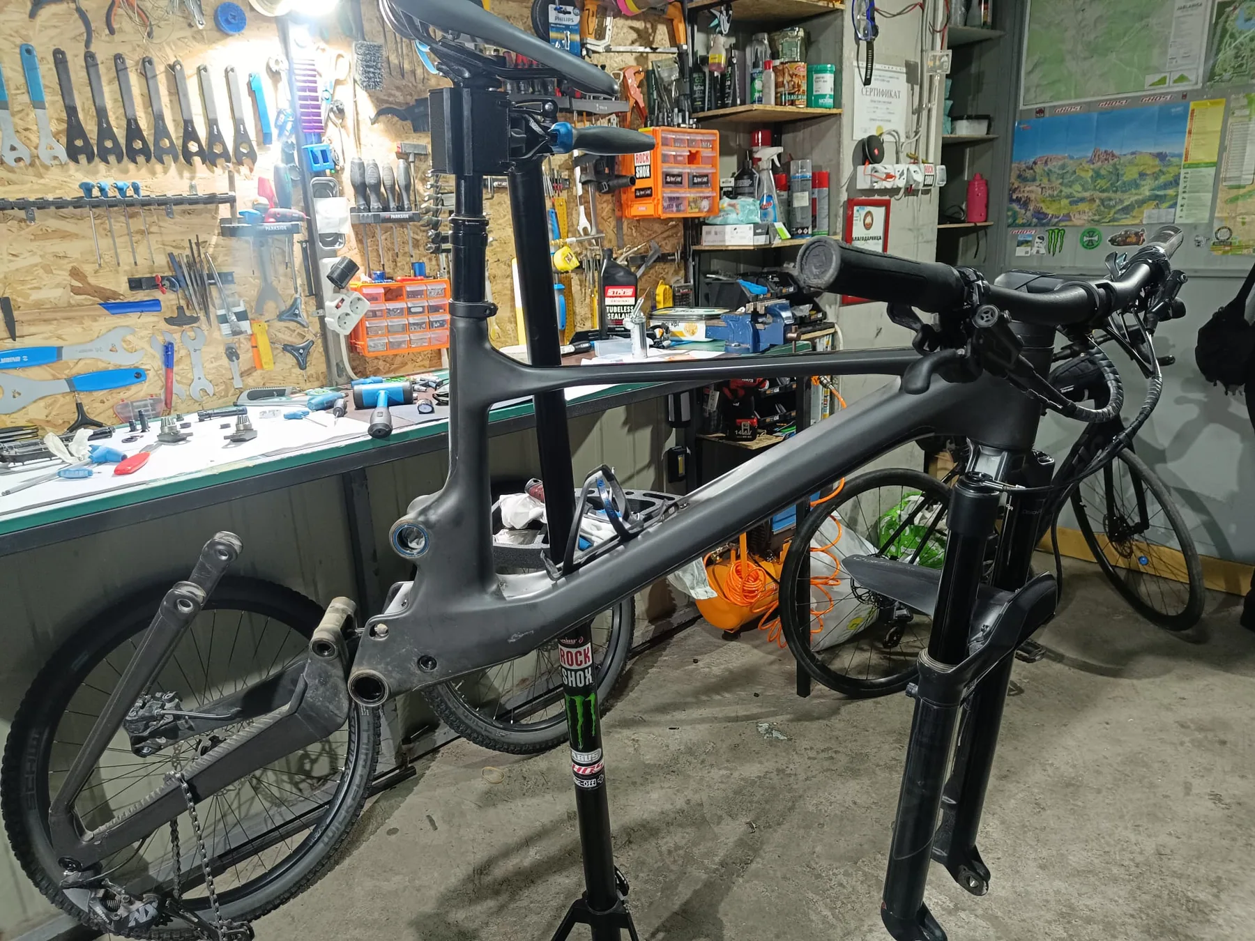 Side view of a mountain bike frame on a service stand