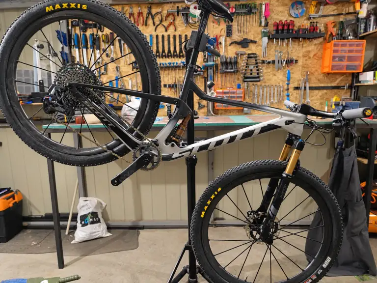 Scott Spark RC with a carbon frame and one-piece carbon wheels on a service stand