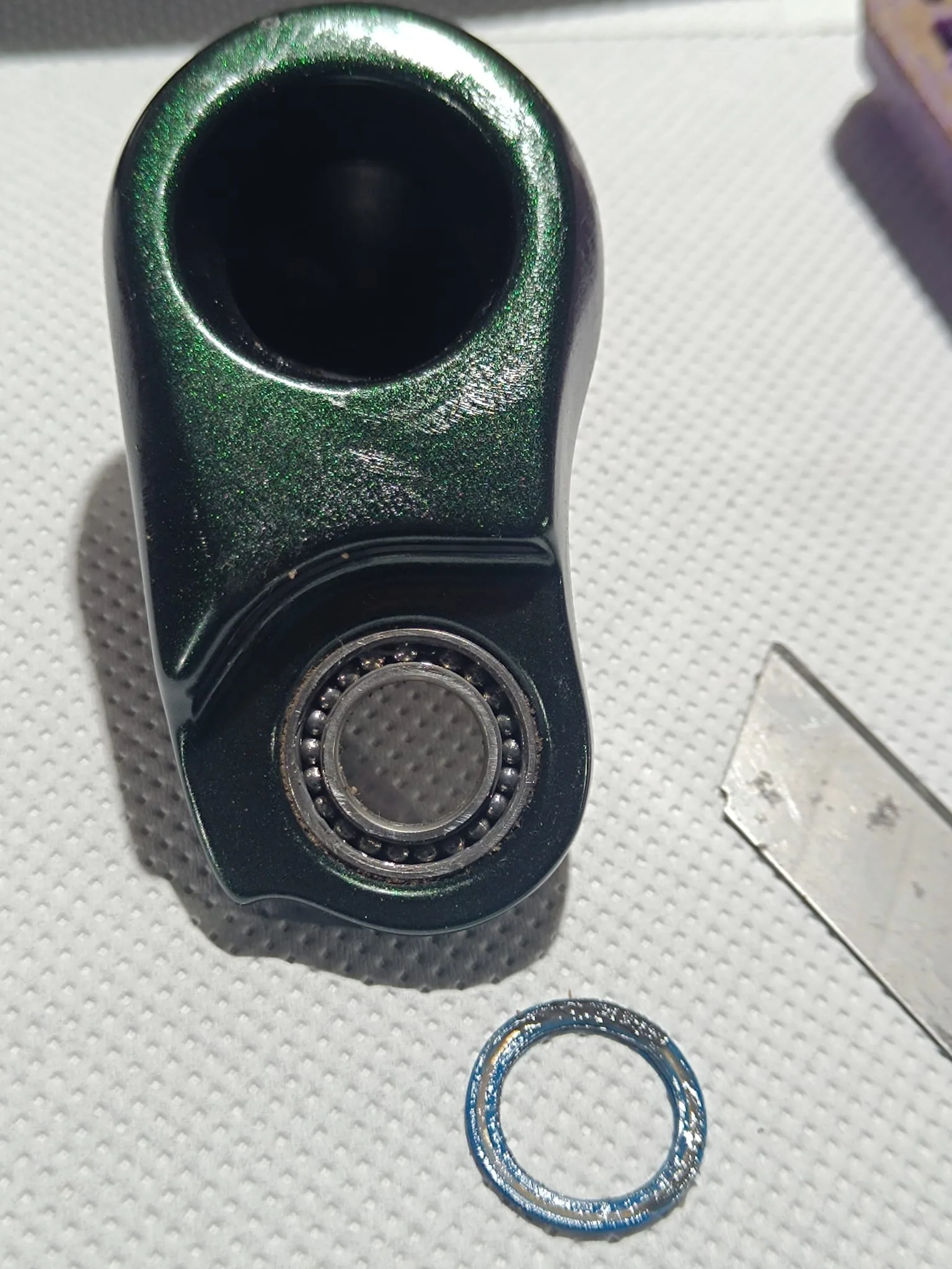 Suspension linkage bearing with its seal removed