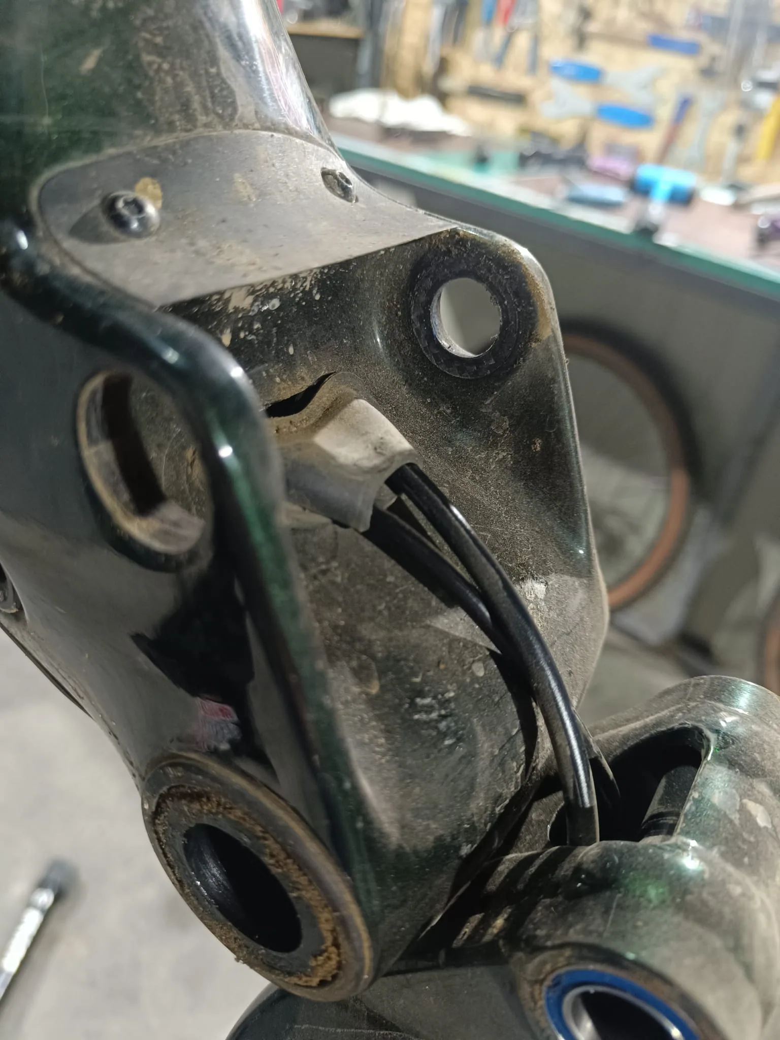 Close-up of the suspension pivot housing during disassembly
